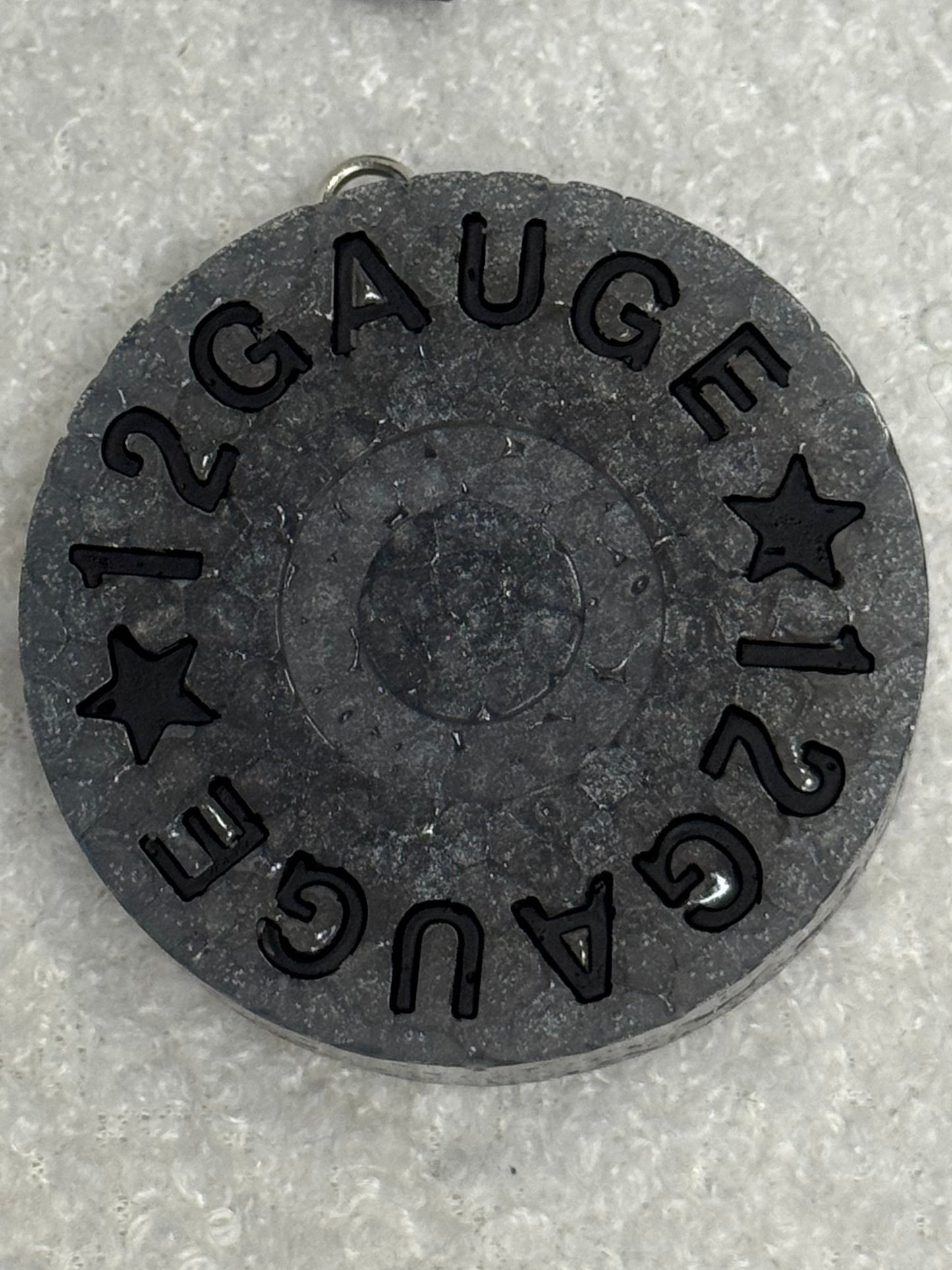 12 gauge shotgun shell on a gray background
