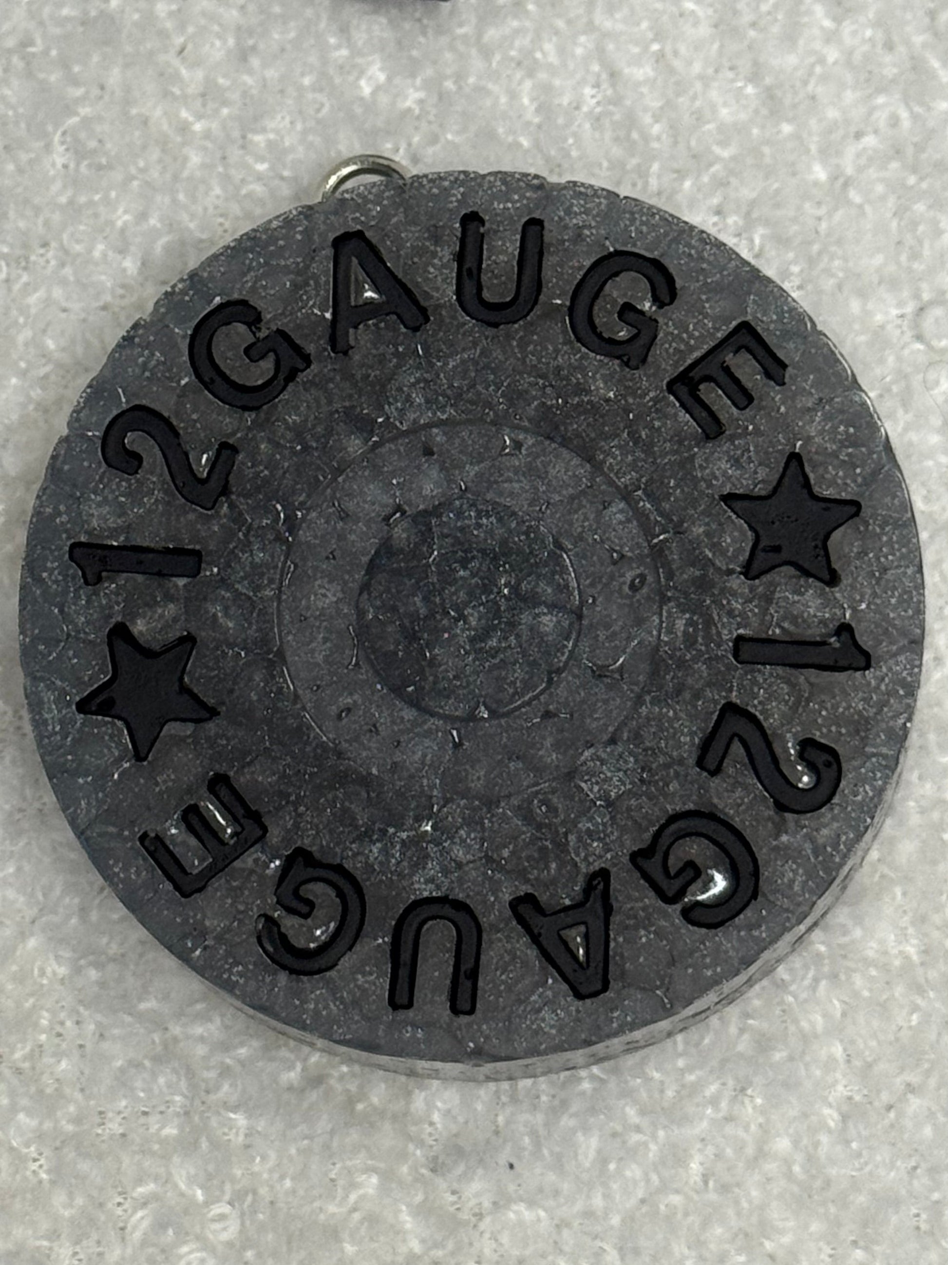 12 gauge shotgun shell on a gray background
